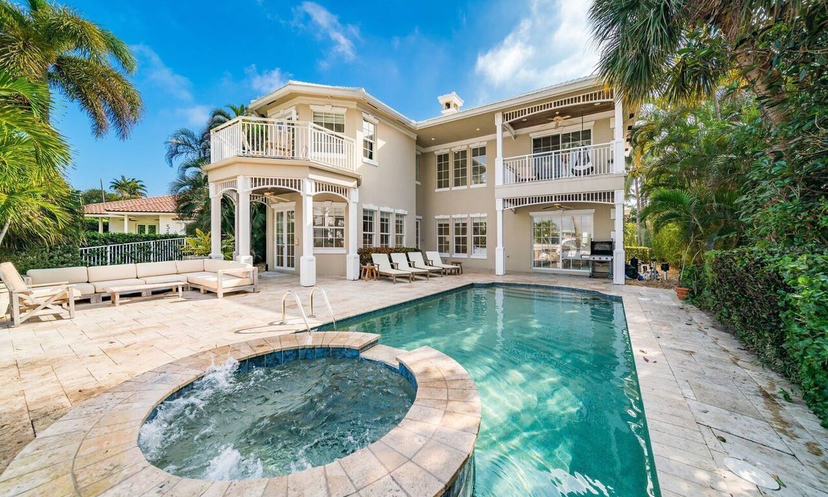 Jog Road House | Canal-Front Retreat Pool + Hot Tub + Dock Walk to Beach | Beach Drive Estate