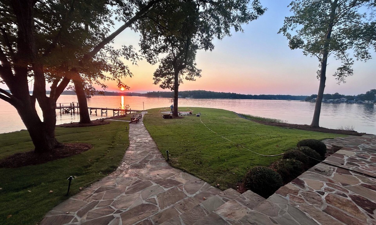 Dadeville House | Perfect for large families & group getaways on Lake Martin. Flat yard + private beach (rare), double-slip dock, and sunset views. Sleeps 16+ with space to spread out, plus firepit + game room for nights in.