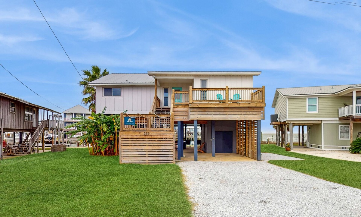 Royal Lagoons House | Serene sound-front home with a covered patio, dock, and swing bed