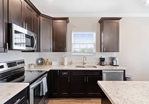 Modern 4BR Mid-City home with heated pool & balcony. Free parking, walk to streetcar & parades.