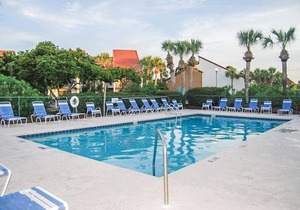 Two-level waterfront condo near beach with balcony, patio, pool & hot tub