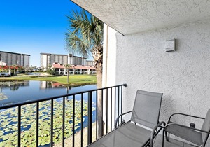 Two-level waterfront condo near beach with balcony, patio, pool & hot tub