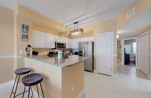 Panama City Beach Condo | Welcoming waterfront condo with a furnished balcony, pool & pool spa