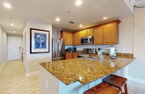 Upper Grand Lagoon Condo | 3rd-floor beach & pool-view condo with outdoor pool, hot tub, grills, balcony