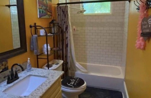 Tulane - Gravier House | bedroom and en suite bath in historic New Orleans home with pool & WiFi