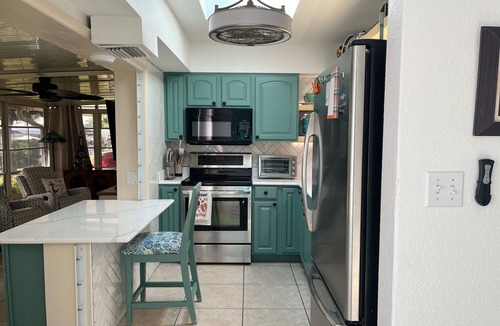 Edgewater House | Cozy South West Florida Escape on canal w/working space & pet friendly.