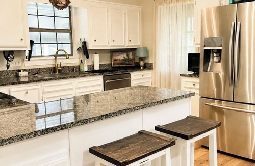 Daphne House | Grand Oak Cottage in Olde Town, 2 King Primary Suites, year round Saltwater Pool