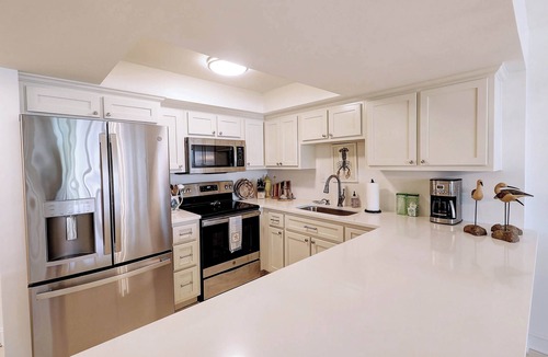 Upper Grand Lagoon Condo | Ground Floor Condo with Shared Pool, Golf Access, Bay Views, and WiFi