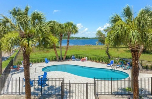 Sunnyside Condo | Islandia 319 Waterfront with Boat Ramp, Pool, and Fishing Dock