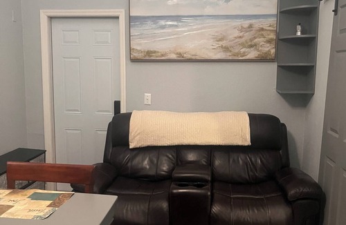 Tampa Heights House | Location Location Mini Jr. Suite. 1-bedroom queen bed behind barn doors.