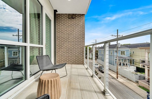 New Orleans Apartment | Modern 2BR Bywater condo with 2 king beds, pool & gym. Balcony, parking, near French Quarter.