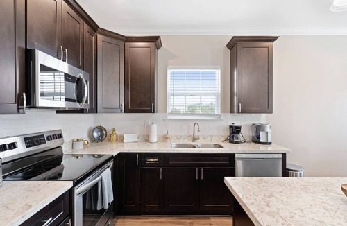 Tulane - Gravier Apartment | Modern 4BR Mid-City home with heated pool & balcony. Free parking, walk to streetcar & parades.