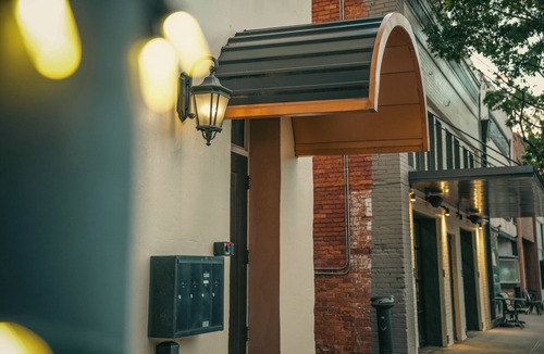 Sulphur Springs Apartment | Nestled in the buzzing heart of Sulphur Springs, White Oak Hotel isn't just a place to stay-it's an invitation to immerse yourself in a vibrant tapestry of creativity, flavor, and untamed beauty. Our intimate three-room retreat, born from historic bo