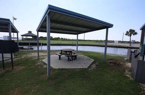 Sabine Pass Cottage | Park your boat in front of the Fishermen's Cottage! Screened in patio.