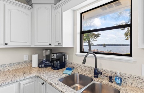 Dadeville House | Perfect for large families & group getaways on Lake Martin. Flat yard + private beach (rare), double-slip dock, and sunset views. Sleeps 16+ with space to spread out, plus firepit + game room for nights in.
