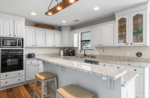 Dadeville House | Perfect for large families & group getaways on Lake Martin. Flat yard + private beach (rare), double-slip dock, and sunset views. Sleeps 16+ with space to spread out, plus firepit + game room for nights in.