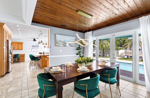 Coral Ridge Isles House | Pool Game Room Outdoor Lounge Private Dock Tiki Hut | Hummingbird Harbor