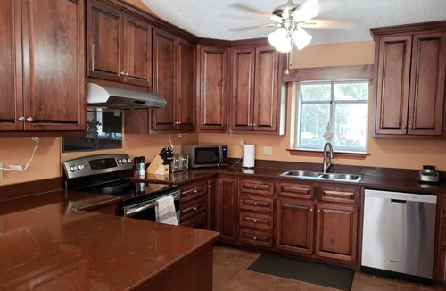 North Northwest Pensacola House | Private Getaway with Screened Pool, Upscale Kitchen, & Large Private Fenced Yard