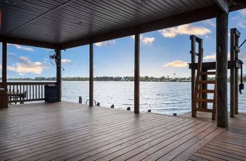 Lakeland House | Screened porch and private pier on False River