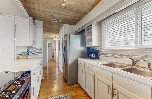 Royal Lagoons House | Serene sound-front home with a covered patio, dock, and swing bed