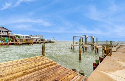 Royal Lagoons House | Serene sound-front home with a covered patio, dock, and swing bed