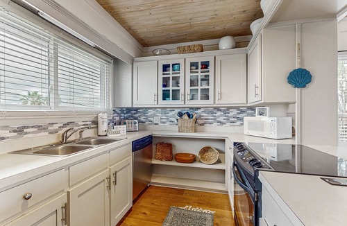 Royal Lagoons House | Serene sound-front home with a covered patio, dock, and swing bed