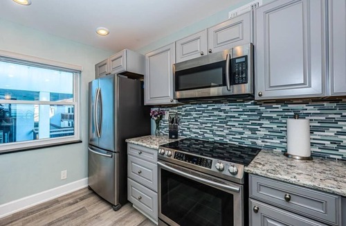Casa del Mar Villa | Waterfront 2BR condo in St. Petersburg with balcony, pool, and hot tub.