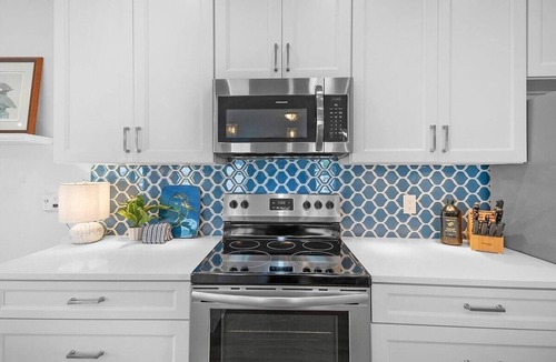 Butler Beach House | Welcome Basket, Swim Spa, Steps to Beach, BBQ!