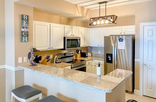 Panama City Beach Condo | Welcoming waterfront condo with a furnished balcony, pool & pool spa