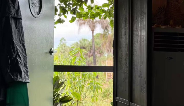 Luxury off-grid passionfruit covered shipping container immersed in nature. in Naples