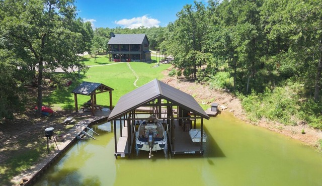 Richland Chambers Lakefront 2-story home with boat dock and pavilions.
