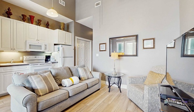 Spacious condo with large living area, private balcony & shared pool