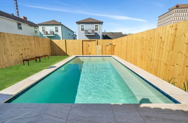 Modern 4BR Mid-City home with heated pool & balcony. Free parking, walk to streetcar & parades.