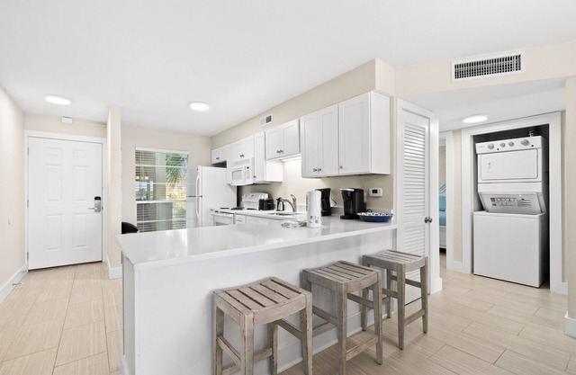 Second floor condo with pool access, ccean view, WiFi, W/D, and central AC