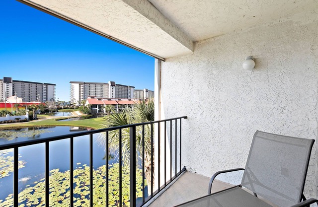 Two-level waterfront condo near beach with balcony, patio, pool & hot tub