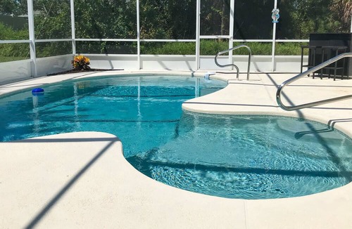 Indian Trails House | The Barefoot Bungalow House in Palm Coast With an Enclosed Pool & Grill