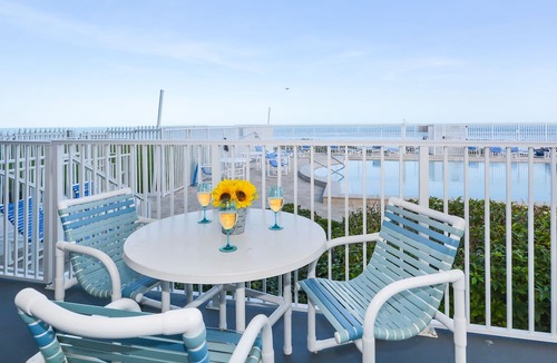 Bethune Beach Condo | Ocean Condo 104 ~ Ground Floor Corner Condo with wrap around balcony! Walk right out to Pool!